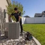 HVAC tech fixing AC unit