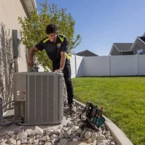 HVAC tech fixing AC unit