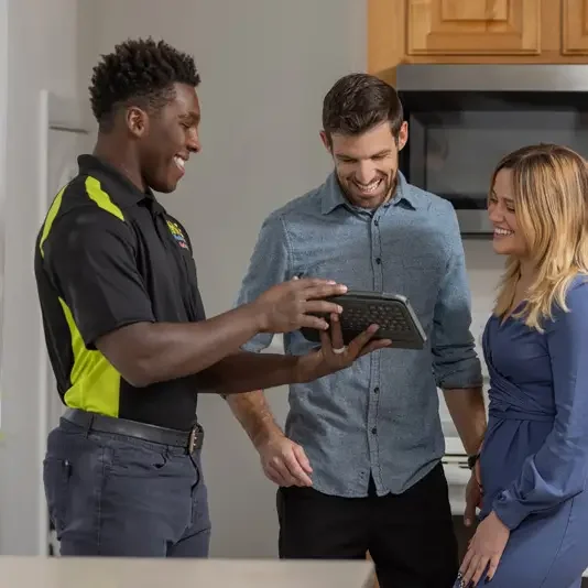 HVAC tech showing tablet to customers