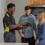 HVAC tech showing tablet to customers