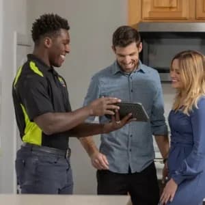 HVAC tech showing tablet to customers