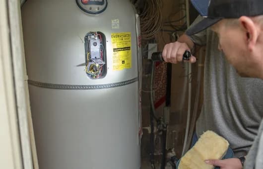 Petersen Plumbing checks a water heater.